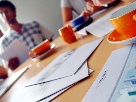 effective meetings - photo of people meeting at a table