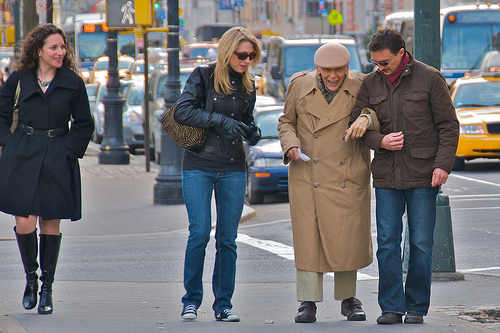 people helping someone cross the street at a crosswalk symbolizing helping others