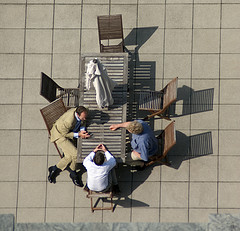 people at a table outdoors discussing a topic